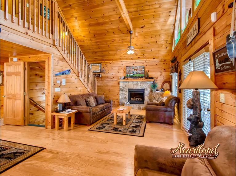 Living Room has a Queen Sleeper Sofa, Cable TV, WIFI, and Fireplace in this 5 bedroom cabin in Pigeon Forge